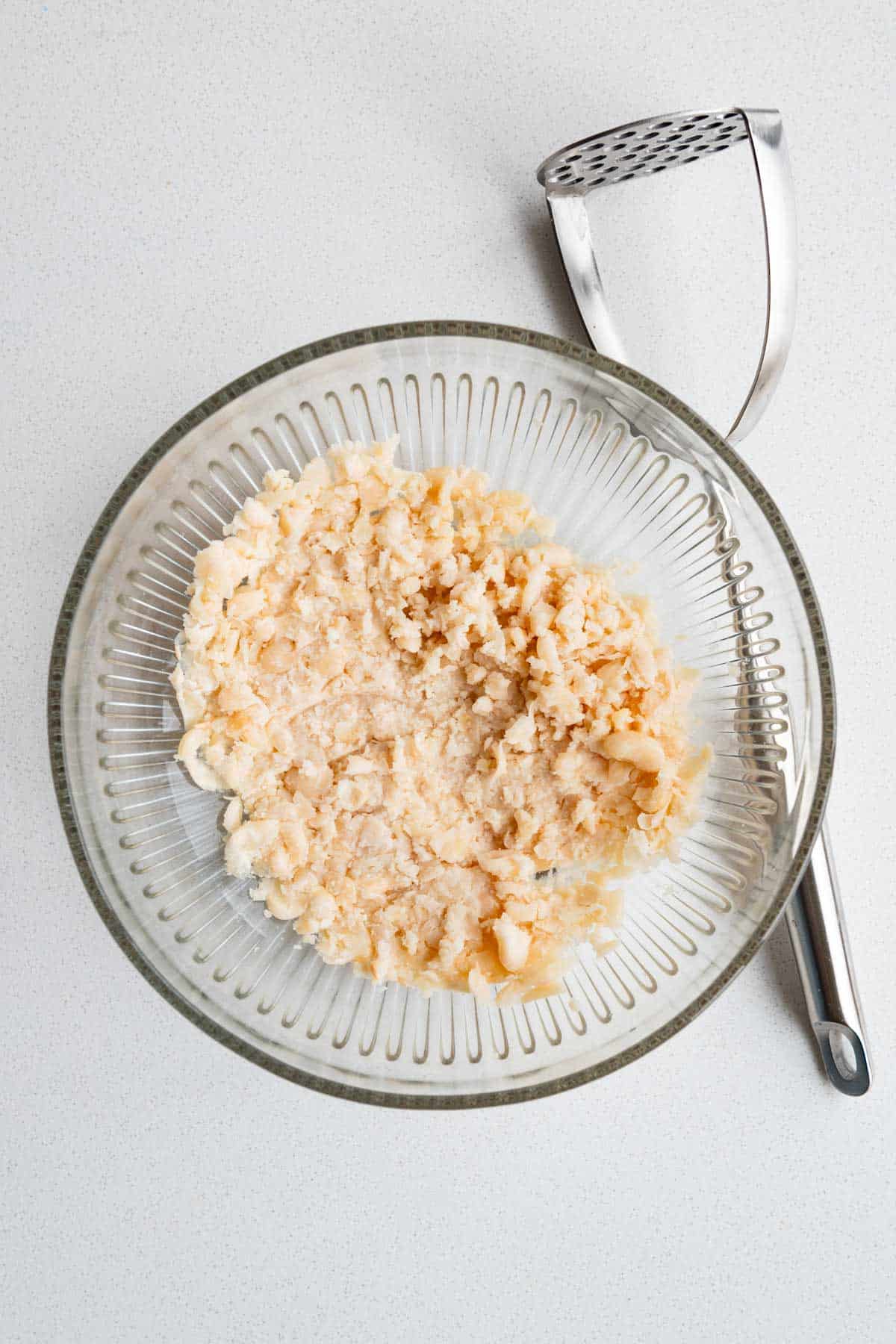 Mashed white beans in a bowl.
