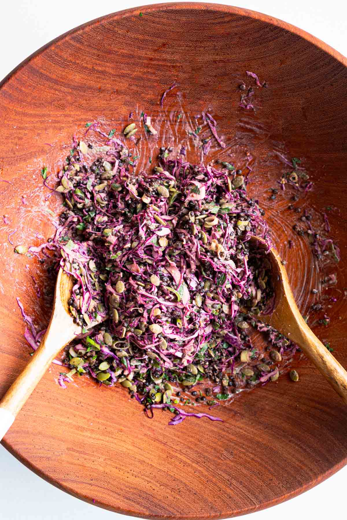 Red cabbage lentil crunch salad in a wooden bowl.