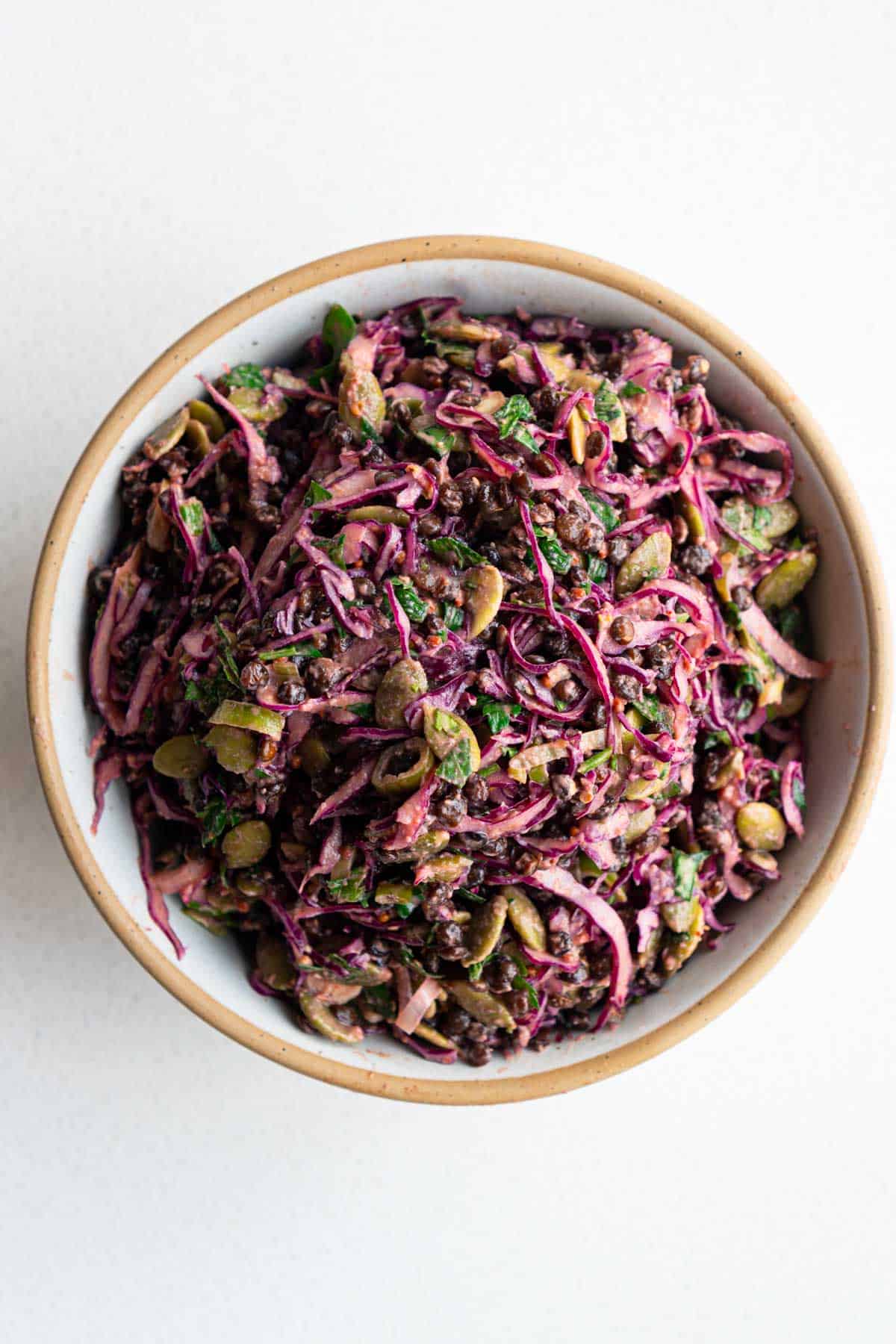 Red cabbage lentil crunch salad in a wooden bowl.