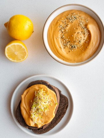 Bell pepper sprouted hummus on pumpernickel bread.