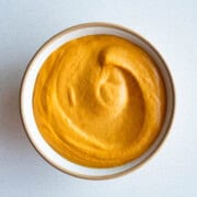 Bell pepper sprouted hummus in a bowl.