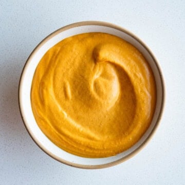 Bell pepper sprouted hummus in a bowl.