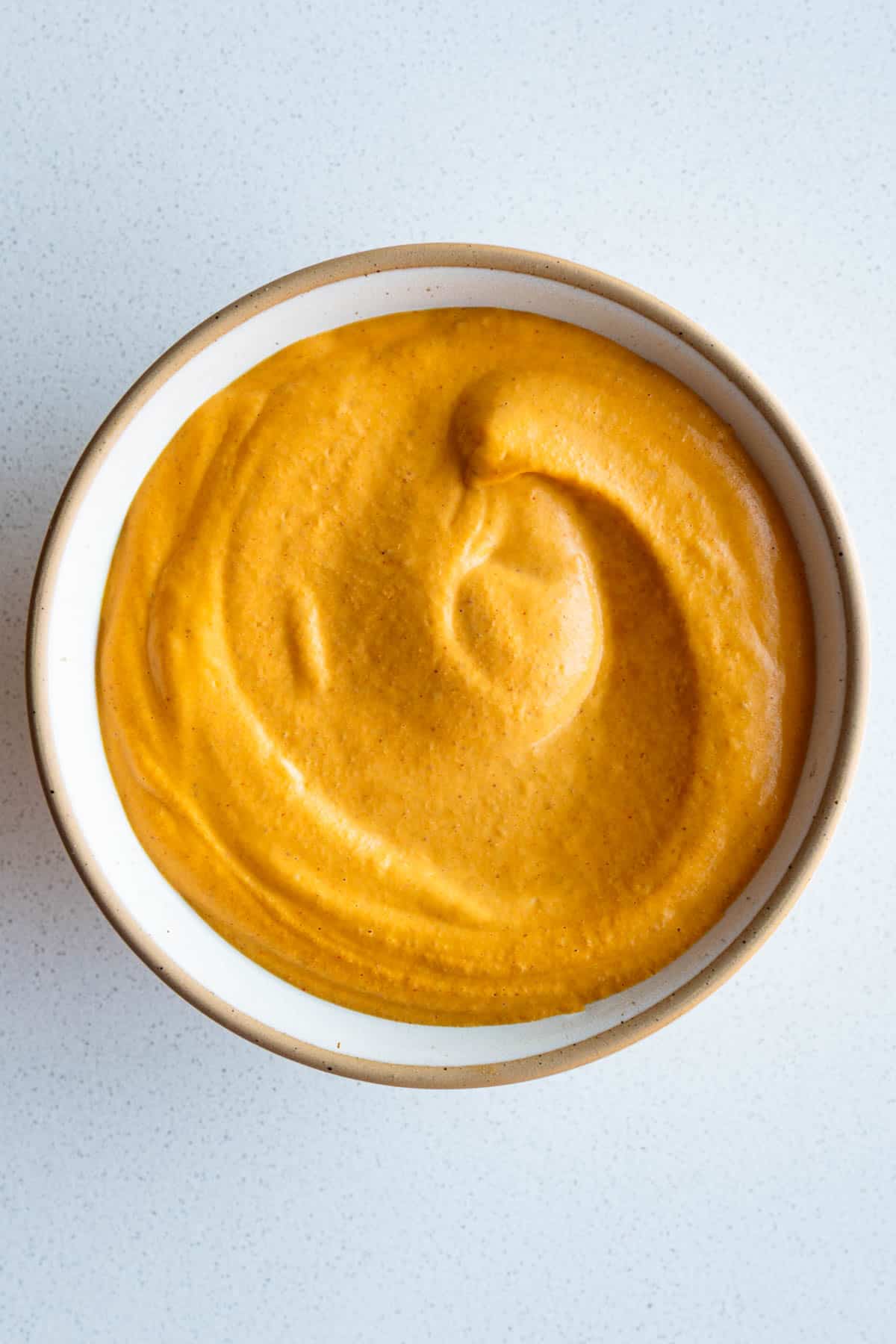 Bell pepper sprouted hummus in a bowl.