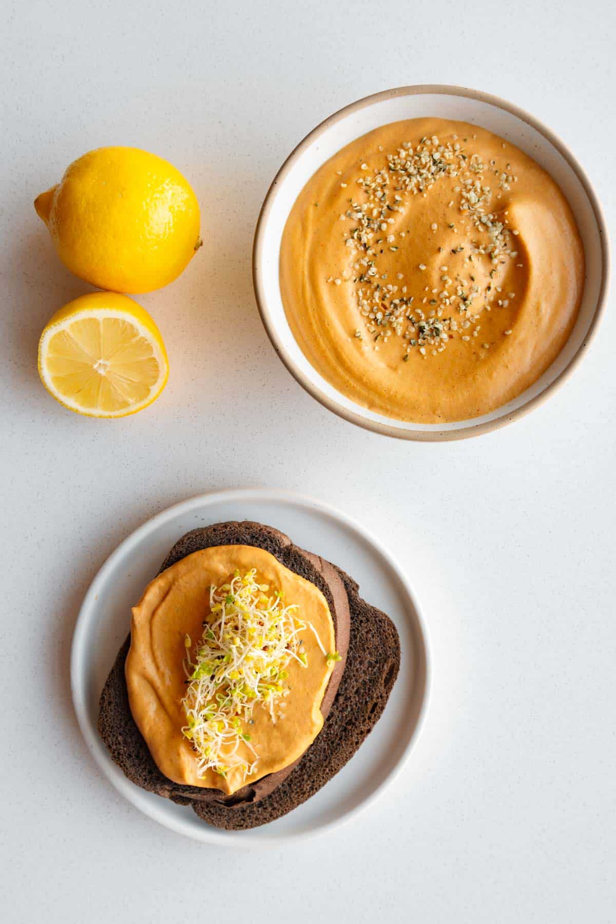 Bell pepper sprouted hummus on pumpernickel bread.