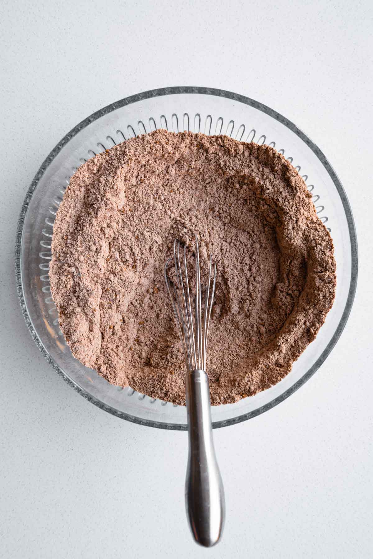 Sorghum flour, oat flour, cocoa powder, and baking powder whisked in a bowl.