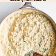White beans in cauliflower cream sauce in a skillet.
