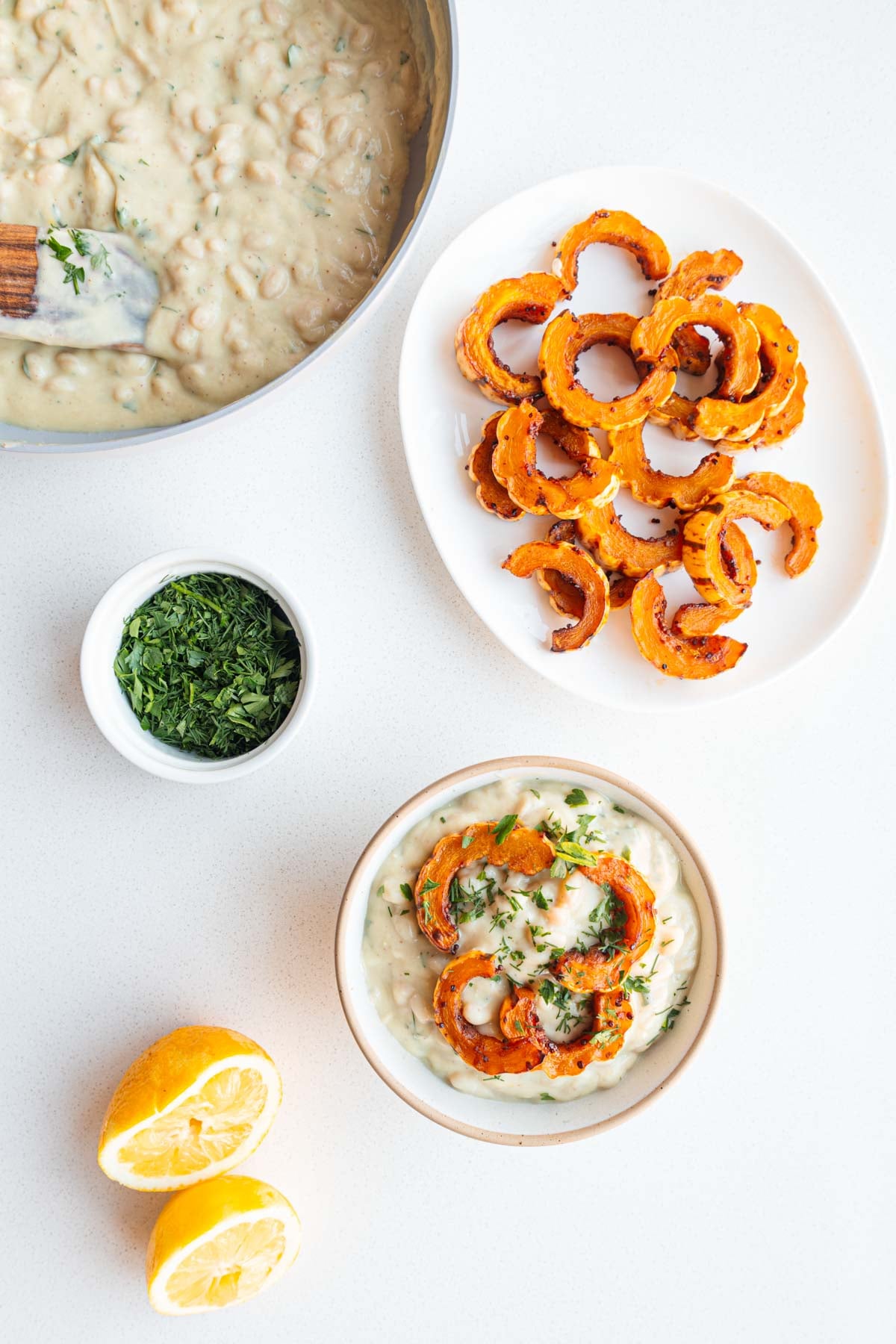 White beans in cauliflower cream sauce, Delicata squash, fresh herbs, and lemon.